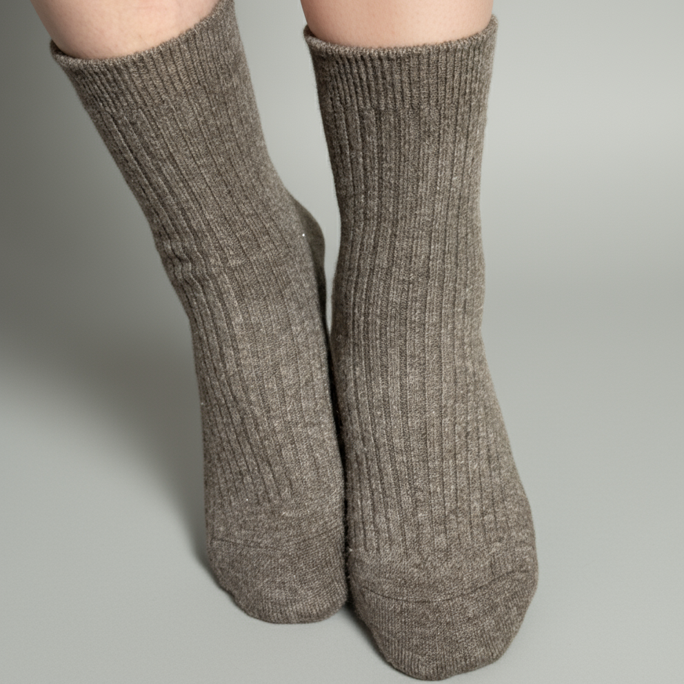 Yak Brown ribbed socks worn on a concrete surface